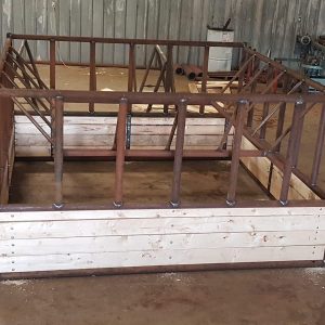 double hay bale feeder made of wood planks and metal framing