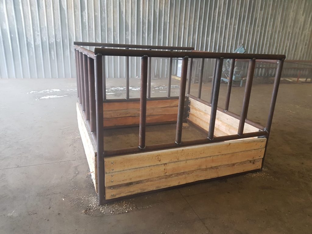 double hay bale feeder made of wood planks and metal framing